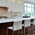 kitchen renovation with large white island and built in sink