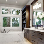 newly renovated bathroom with built in tub and glass shower